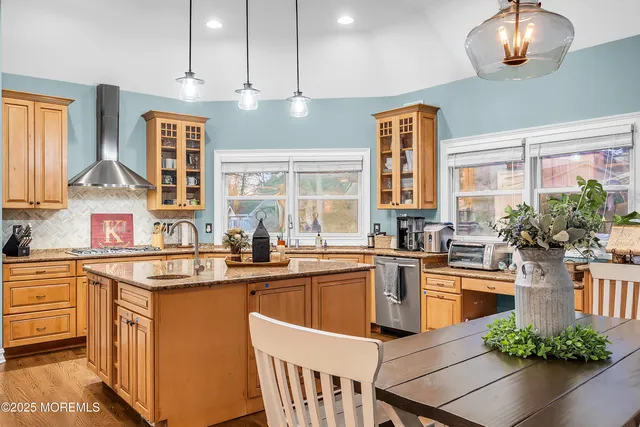 a kitchen with granite countertop stainless steel appliances and counter space