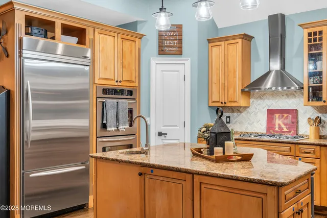 a kitchen with stainless steel appliances granite countertop a sink and dishwasher a oven with wooden cabinets