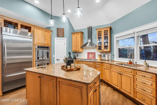 a kitchen with stainless steel appliances granite countertop a sink and cabinets