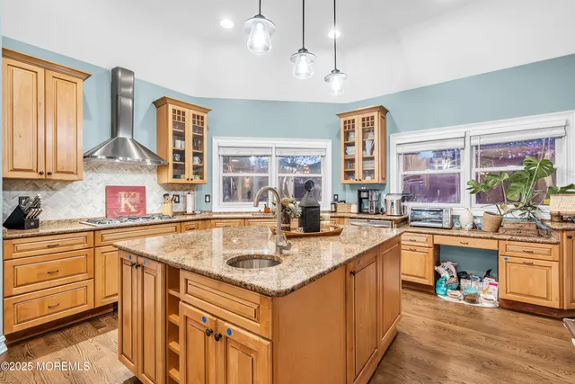 a living room with patio furniture and a wooden floor