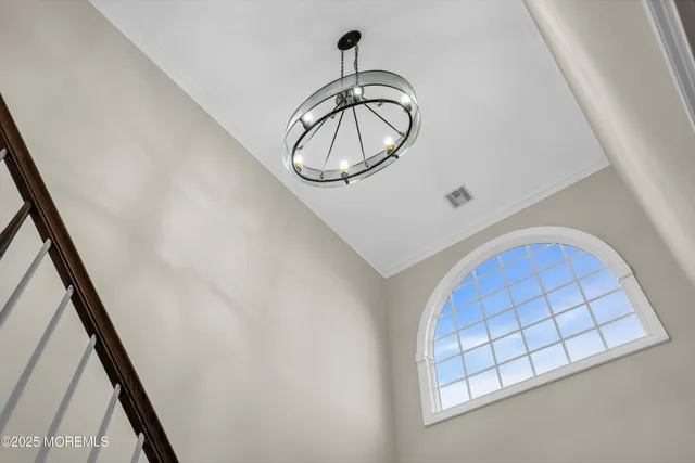a view of staircase with railing and white walls