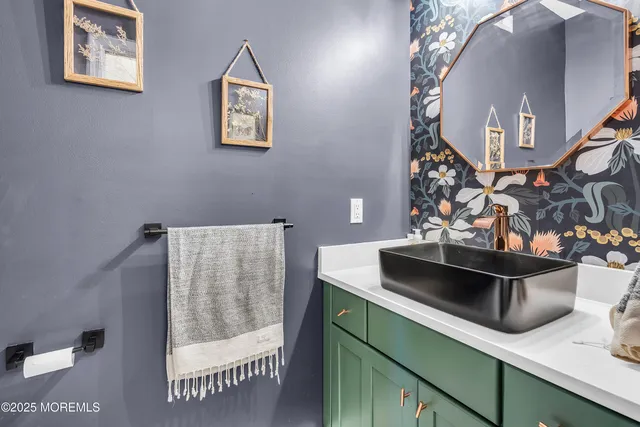 a spacious bathroom with a granite countertop sink and a mirror