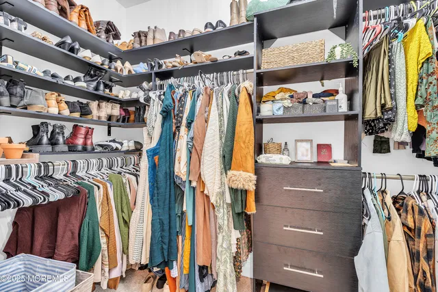 a white bath tub sitting next to a shower