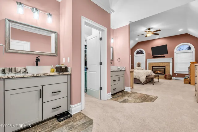 a spacious bedroom with a bed and a fireplace