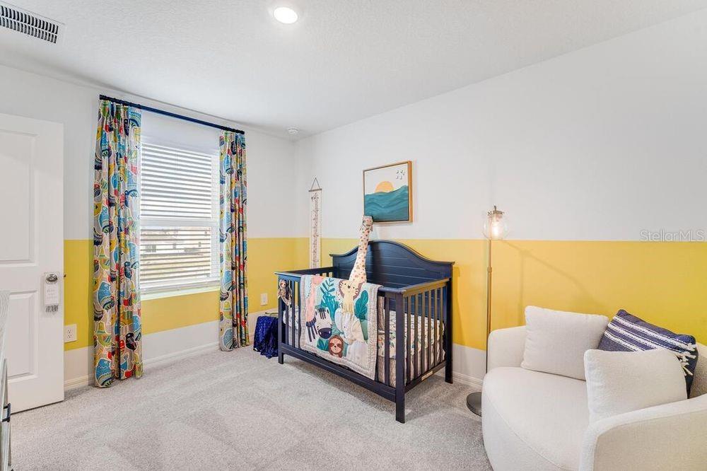 13812 Shellmore Avenue Palmetto, FL 34221 - Photo 22 of 30 a bedroom with furniture and a lamp