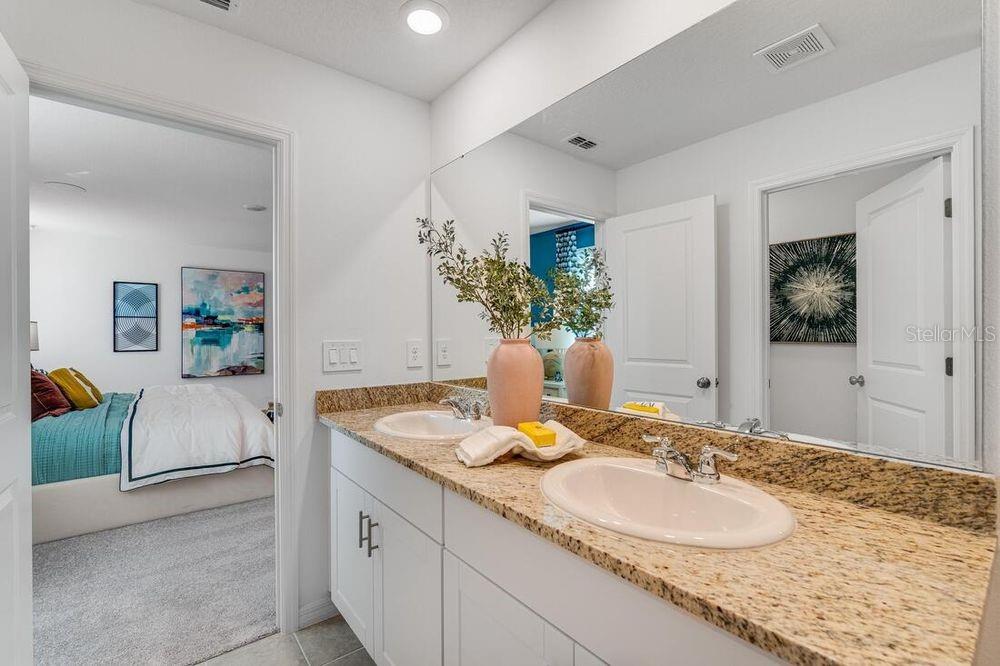 13812 Shellmore Avenue Palmetto, FL 34221 - Photo 24 of 30 a bathroom with a granite countertop sink and a mirror