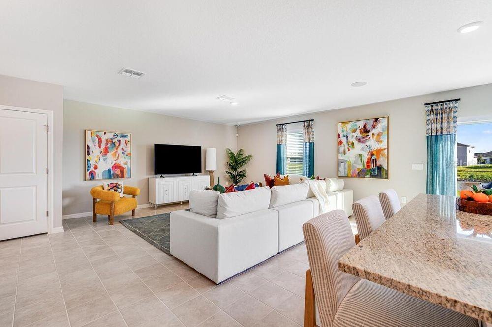 13812 Shellmore Avenue Palmetto, FL 34221 - Photo 7 of 30 a living room with furniture and a flat screen tv