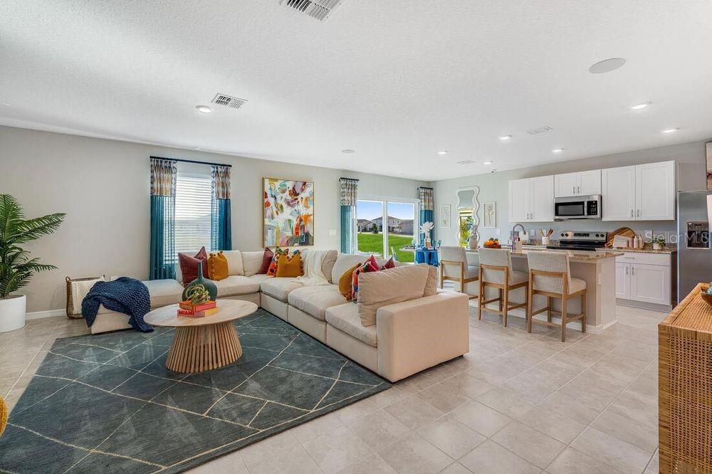 13812 Shellmore Avenue Palmetto, FL 34221 - Photo 8 of 30 a living room with furniture and kitchen view