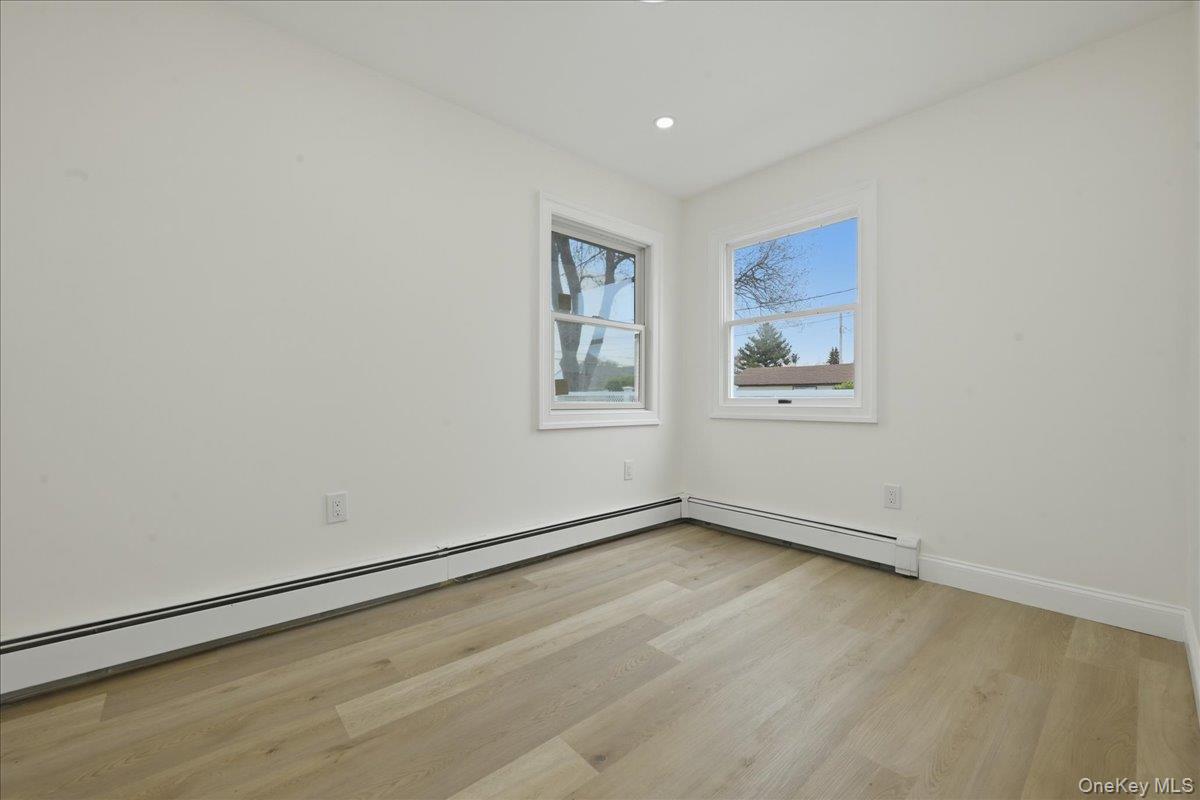 84 North Fordham Road Hicksville, NY 11801 - Photo 16 of 28 an empty room with a workbench