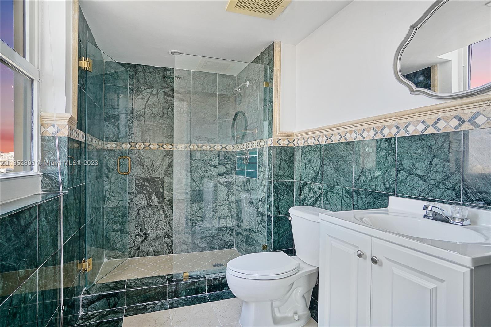 2665 Southwest 37th Avenue, Unit 914 Miami, FL 33133 - Photo 12 of 30 a bathroom with a sink a toilet and shower