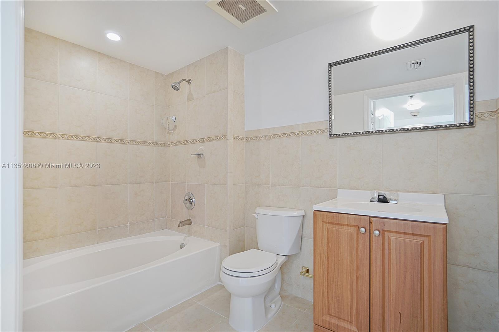 2665 Southwest 37th Avenue, Unit 914 Miami, FL 33133 - Photo 18 of 30 a bathroom with a sink a toilet and shower