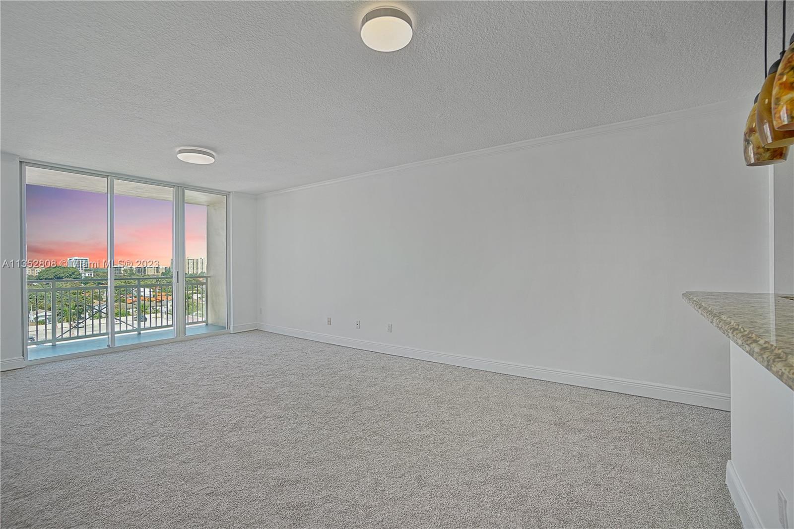 2665 Southwest 37th Avenue, Unit 914 Miami, FL 33133 - Photo 8 of 30 an empty room with windows and city view