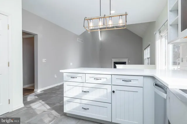 a kitchen with cabinets appliances and a counter top space