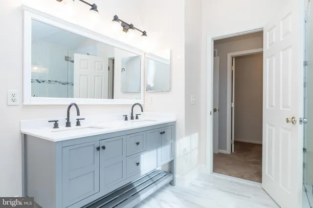 a bathroom with a tub sink toilet and a mirror