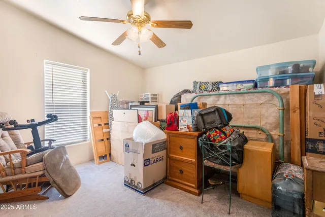 a living room with furniture gym equipment and a large window
