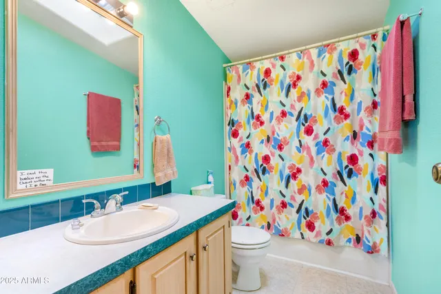 a living room with furniture a rug and a window