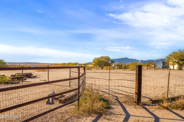 a backyard of a house with barbeque oven table and chairs
