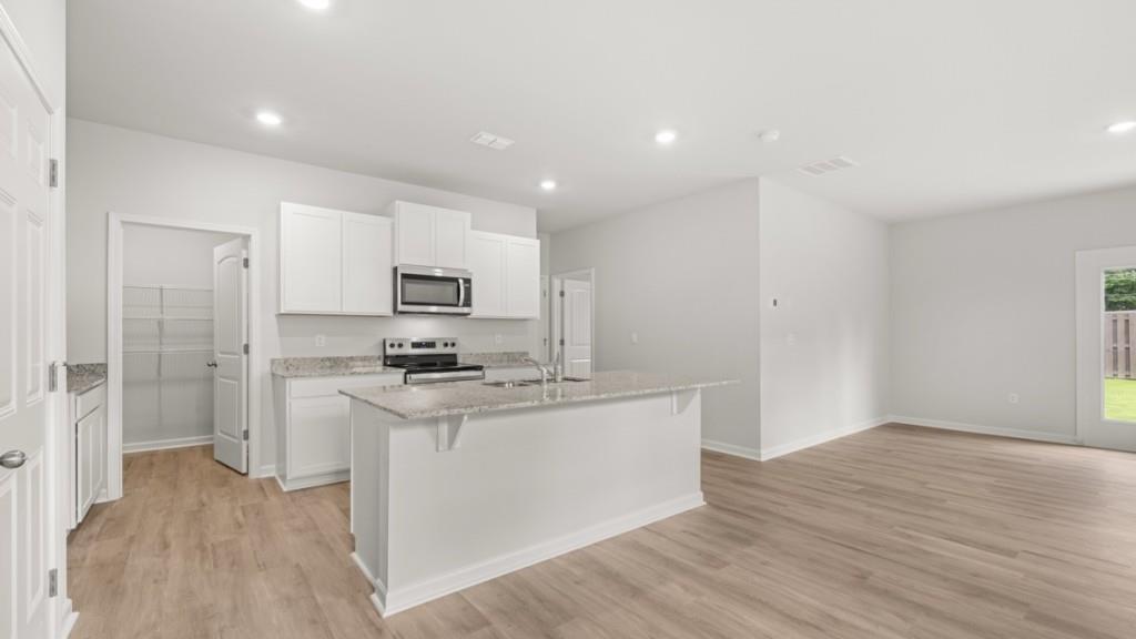 10 Coggins Place Northeast Rome, GA 30165 - Photo 5 of 52 a kitchen with stainless steel appliances granite countertop a stove top oven a sink and a refrigerator