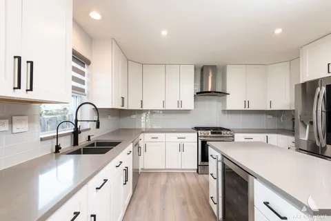 a kitchen with a sink cabinets and stainless steel appliances