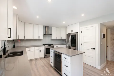 a kitchen with a sink a stove a refrigerator and cabinets