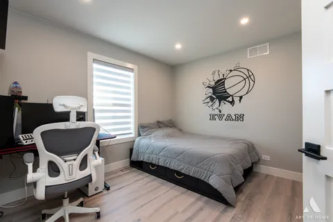 a bedroom with a bed and a chair