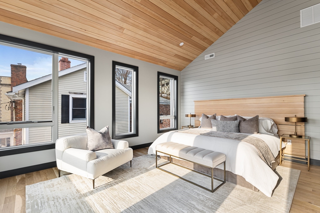 267 Tappan Street, Unit 1 Brookline, MA 02445 - Photo 15 of 23 a spacious bedroom with a bed couch and a window