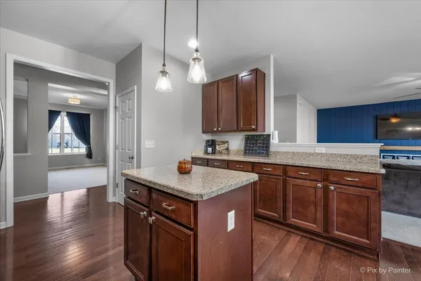 a view of a dining room with furniture and wooden floor