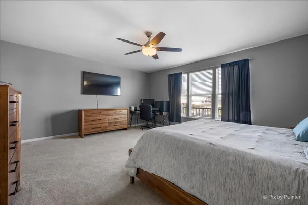 a bedroom with a bed a furniture and a flat screen tv