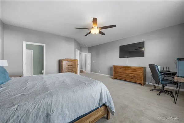 a spacious bathroom with a double vanity sink a large mirror and a shower