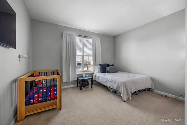 a bedroom with a bed and a view of bedroom