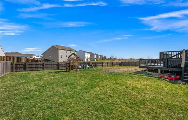 a roof deck with a dining table and chairs with wooden floor