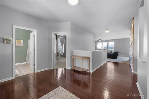 a view of an empty room and wooden floor
