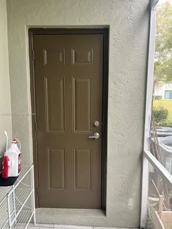 a view of a livingroom with a chair and a large window