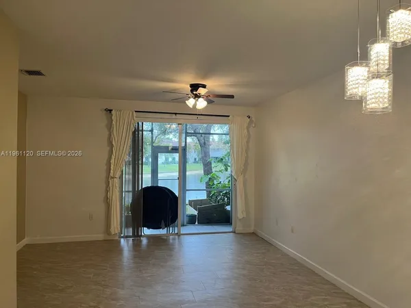 a view of a room with furniture and a window