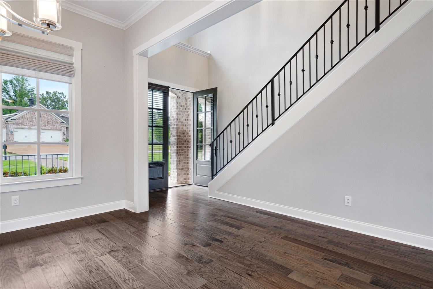 680 Magnolia Lane Piperton, TN 38017 - Photo 12 of 40 Foyer with crown molding, a chandelier, baseboards, dark wood-style flooring, and stairway