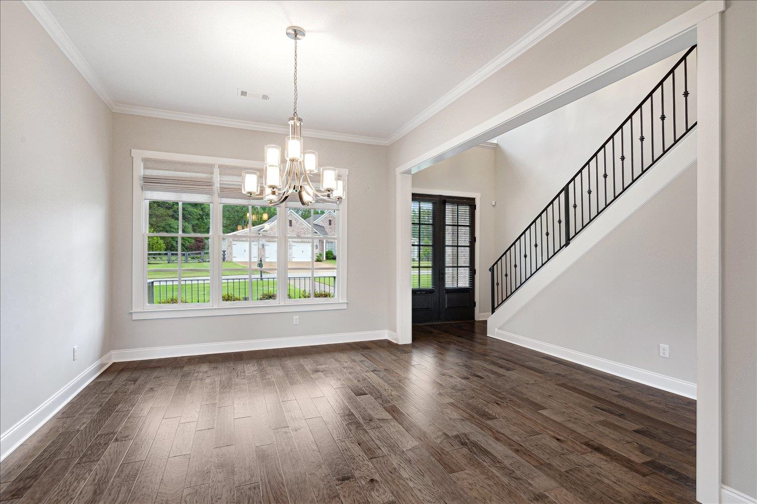 680 Magnolia Lane Piperton, TN 38017 - Photo 14 of 40 Unfurnished dining area featuring a chandelier, dark wood-style floors, ornamental molding, and baseboards
