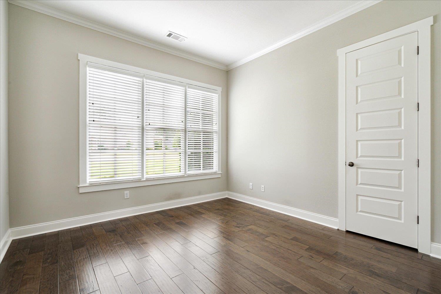 680 Magnolia Lane Piperton, TN 38017 - Photo 20 of 40 Second Bedroom Downstairs featuring baseboards, ornamental molding, and dark wood-type flooring