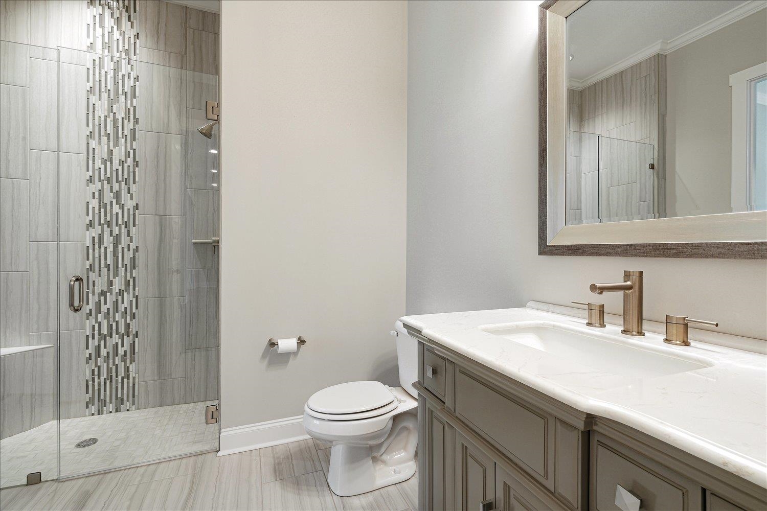 680 Magnolia Lane Piperton, TN 38017 - Photo 21 of 40 Full bath with a stall shower, toilet, baseboards, crown molding, and vanity