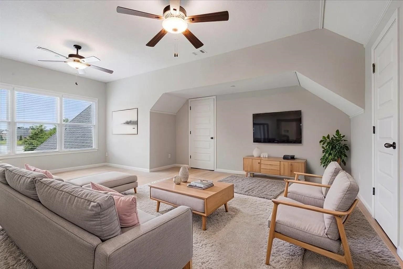 680 Magnolia Lane Piperton, TN 38017 - Photo 22 of 40 Spacious living area featuring multiple windows, recessed lighting, and two ceiling fans. Staged Photo.