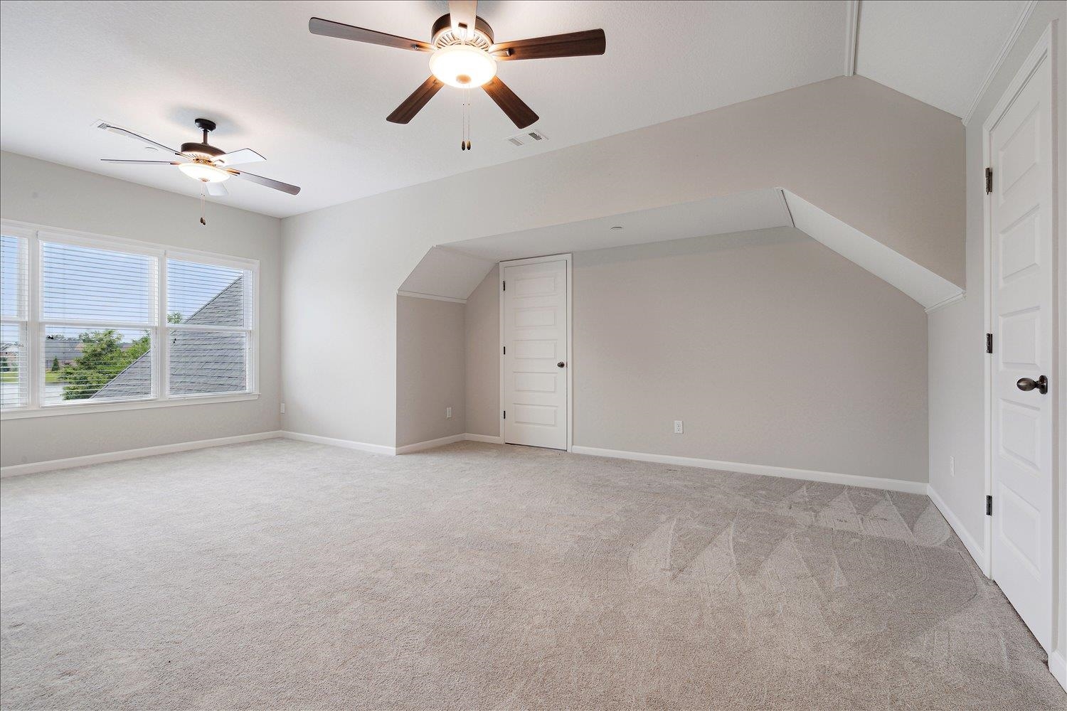 680 Magnolia Lane Piperton, TN 38017 - Photo 23 of 40 Bonus room featuring ceiling fan, light carpet, lofted ceiling, and baseboards