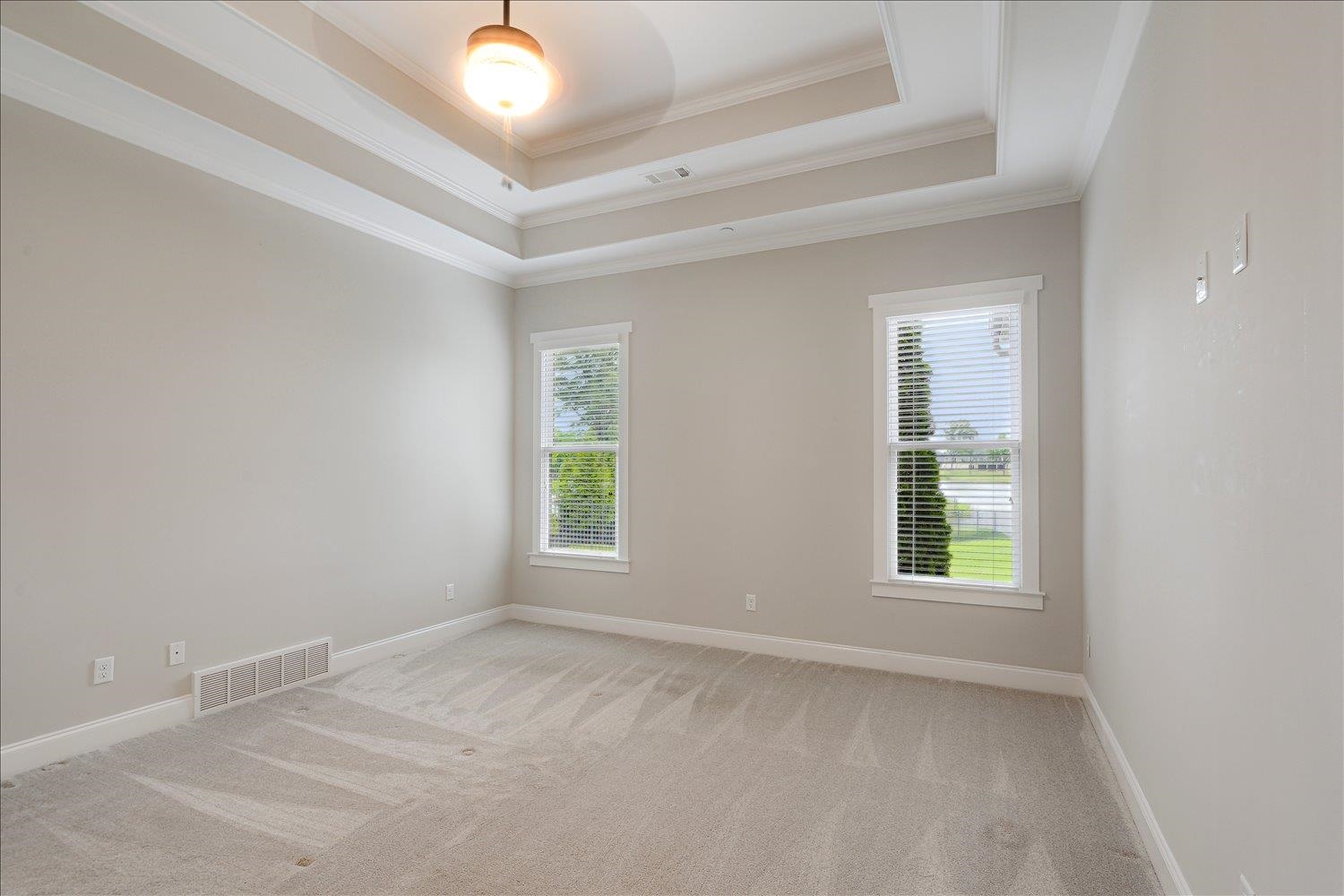 680 Magnolia Lane Piperton, TN 38017 - Photo 26 of 40 Upstairs Bedroom featuring carpet flooring, crown molding, a raised ceiling, and baseboards