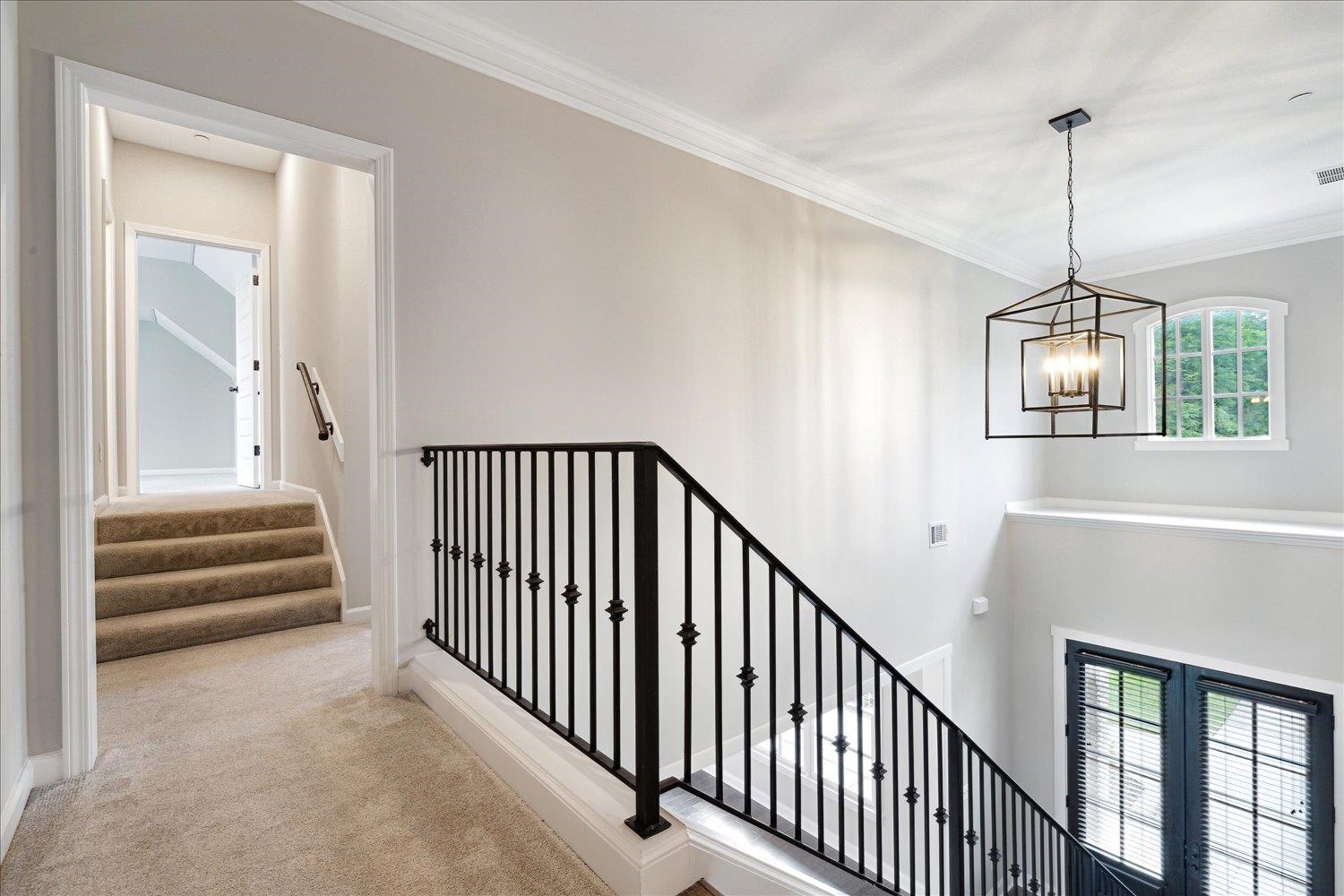 680 Magnolia Lane Piperton, TN 38017 - Photo 27 of 40 Staircase with a chandelier, carpet, ornamental molding, and baseboards