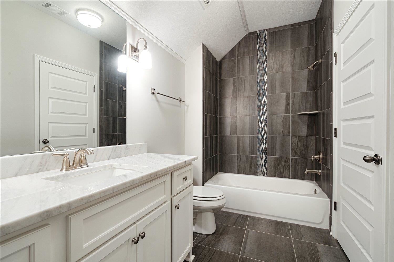 680 Magnolia Lane Piperton, TN 38017 - Photo 29 of 40 Full bath with toilet, shower / tub combination, vanity, and vaulted ceiling