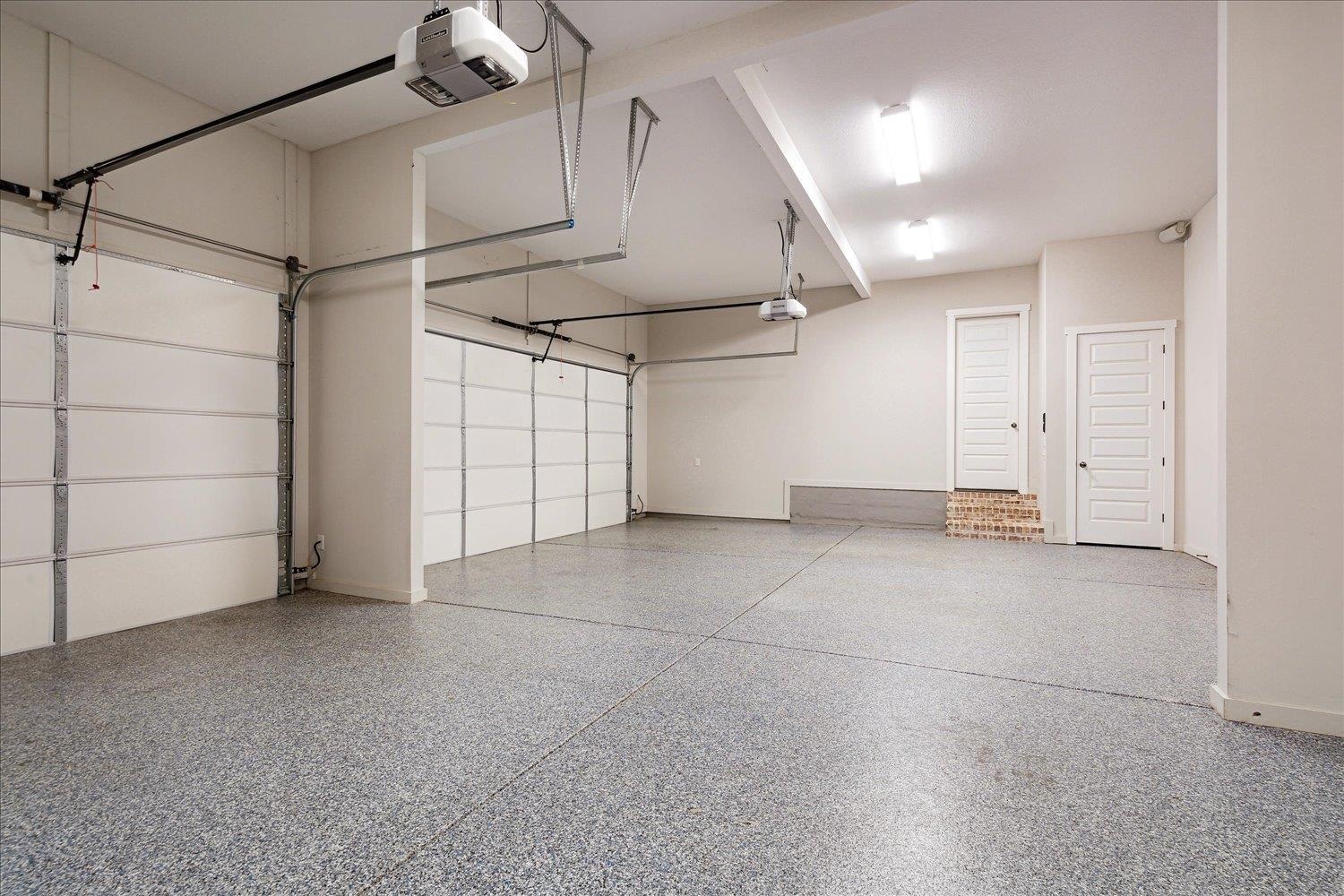 680 Magnolia Lane Piperton, TN 38017 - Photo 37 of 40 Oversized 3 Car Garage (33 X 24) with 12 foot ceilings. Extra width/depth to accommodate larger vehicles & additional storage needs. Dual Storage Closets and Epoxy Floors. 220v for charging station, power tools, etc.
