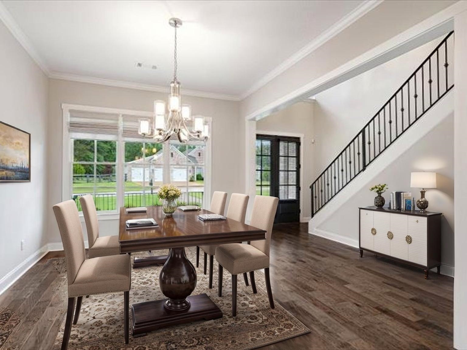 680 Magnolia Lane Piperton, TN 38017 - Photo 4 of 40 Staged Dining area with a chandelier, dark wood-style flooring, crown molding, and stairs