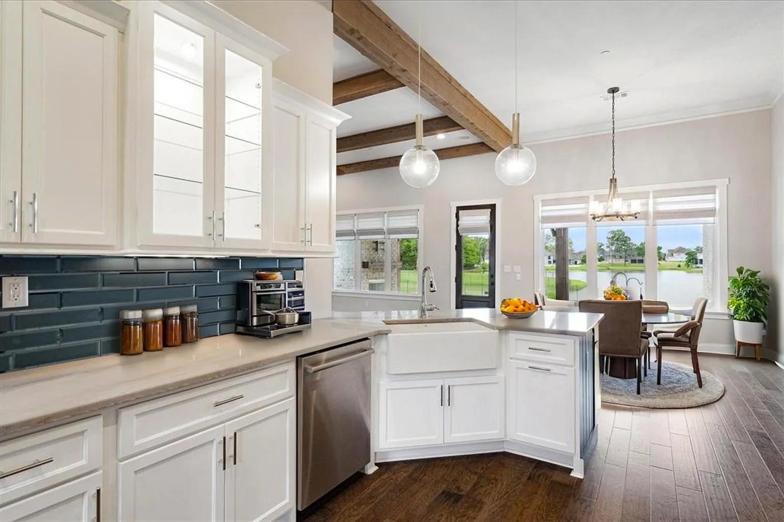 680 Magnolia Lane Piperton, TN 38017 - Photo 6 of 40 Gourmet kitchen featuring white cabinetry, a deep blue subway tile backsplash, stainless steel appliances, and a farmhouse sink