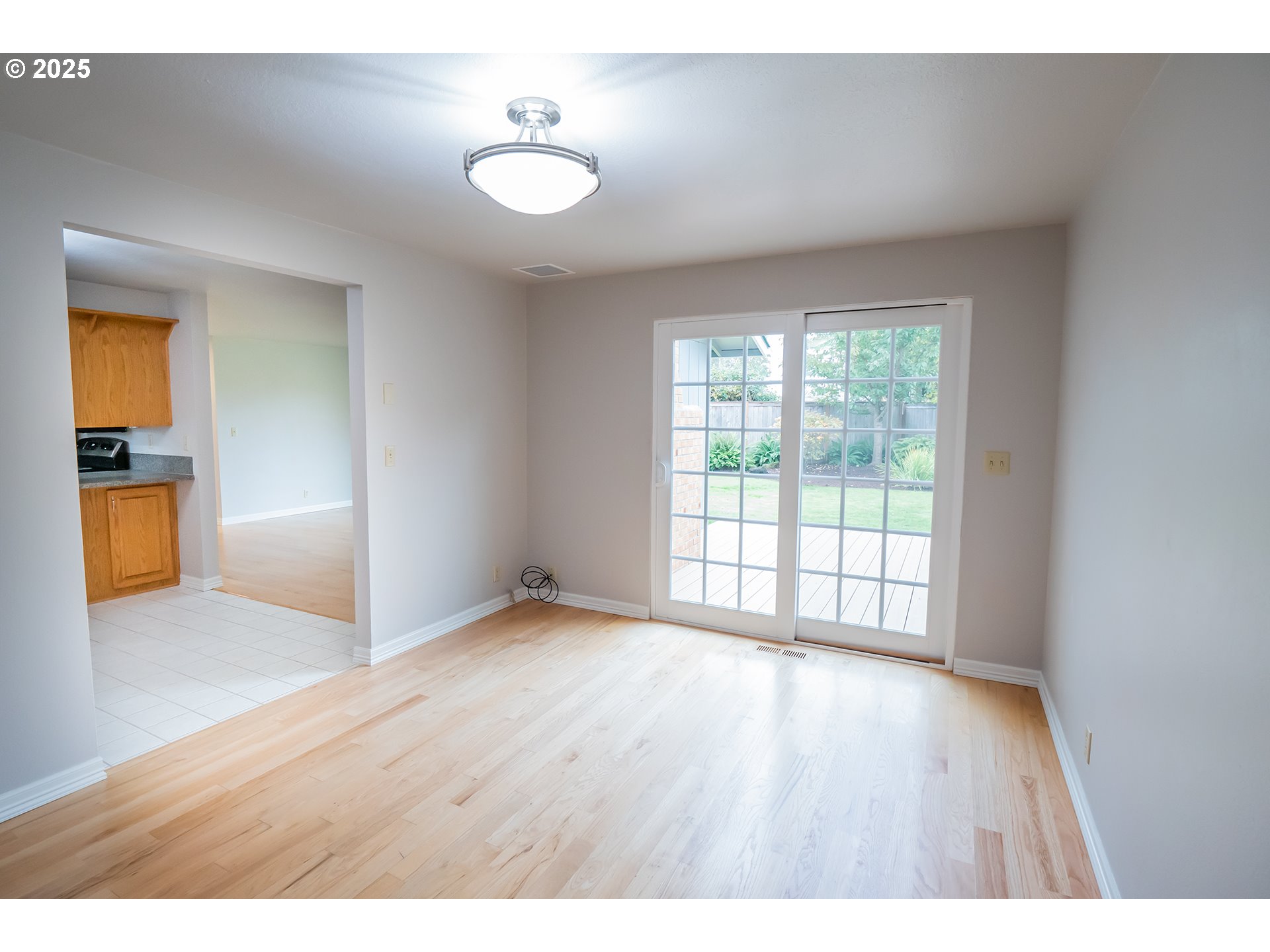 2556 Dumas Drive Springfield, OR 97477 - Photo 12 of 48 a view of an empty room with a window and wooden floor