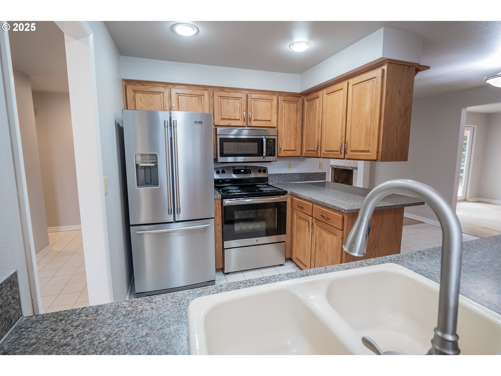 2556 Dumas Drive Springfield, OR 97477 - Photo 16 of 48 a kitchen with stainless steel appliances granite countertop a refrigerator a stove a sink a washer dryer and a refrigerator