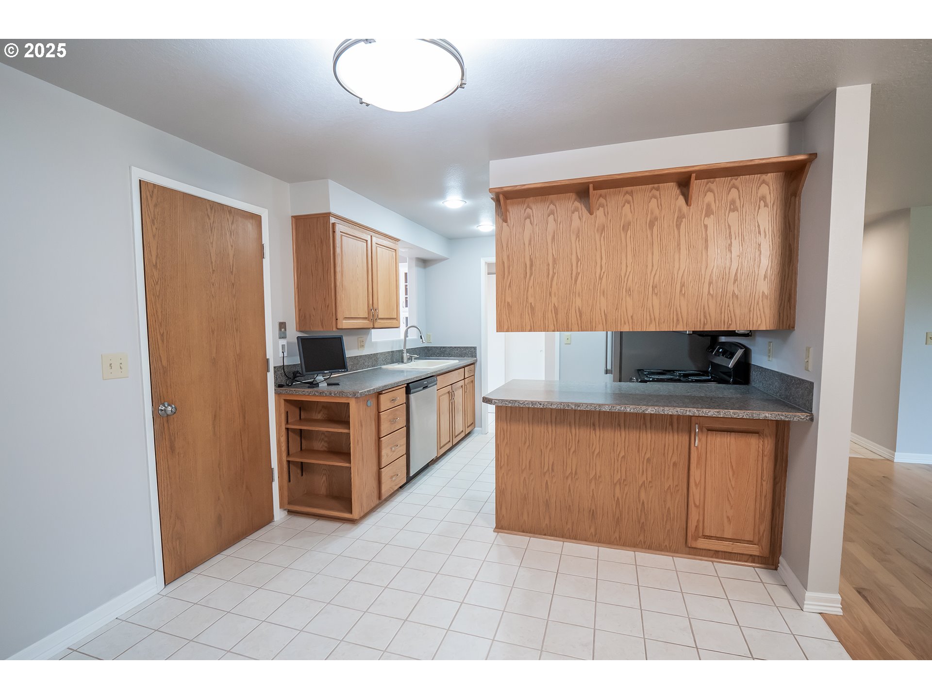 2556 Dumas Drive Springfield, OR 97477 - Photo 18 of 48 a kitchen with stainless steel appliances granite countertop a stove a sink and a refrigerator