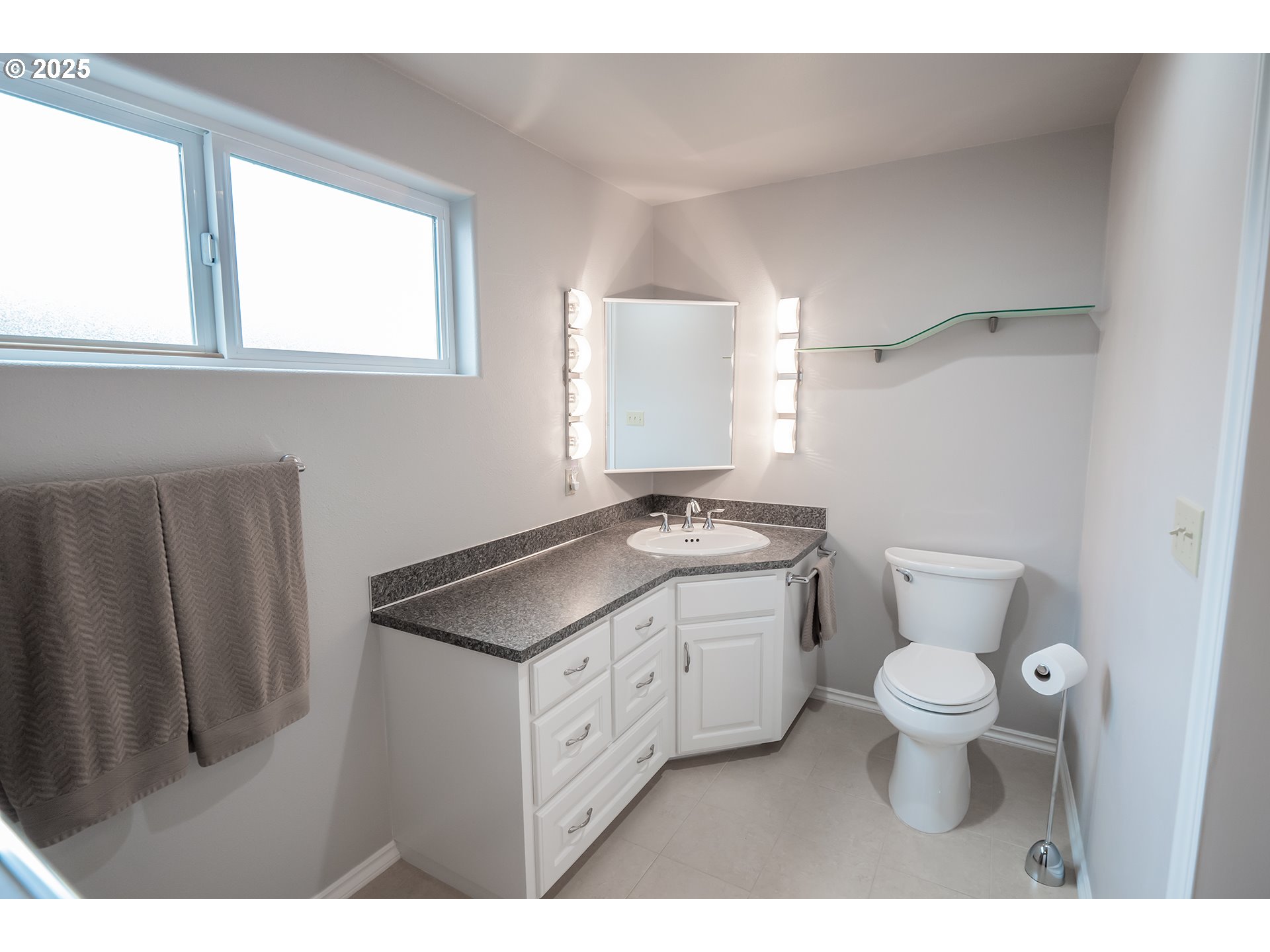 2556 Dumas Drive Springfield, OR 97477 - Photo 29 of 48 a bathroom with a granite countertop sink toilet and mirror